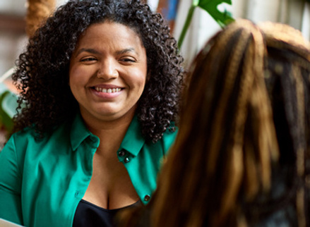 Woman being interviewed and smiling